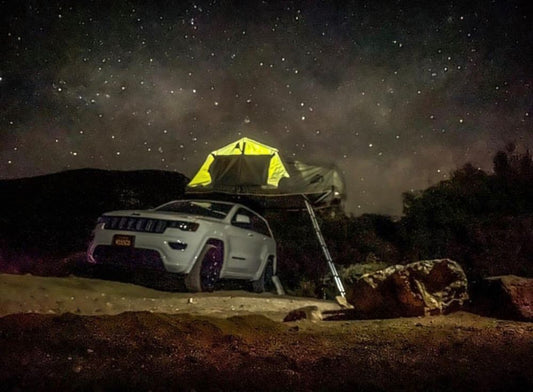 Luxury camping with hard shell tent on car under the stars in Utah